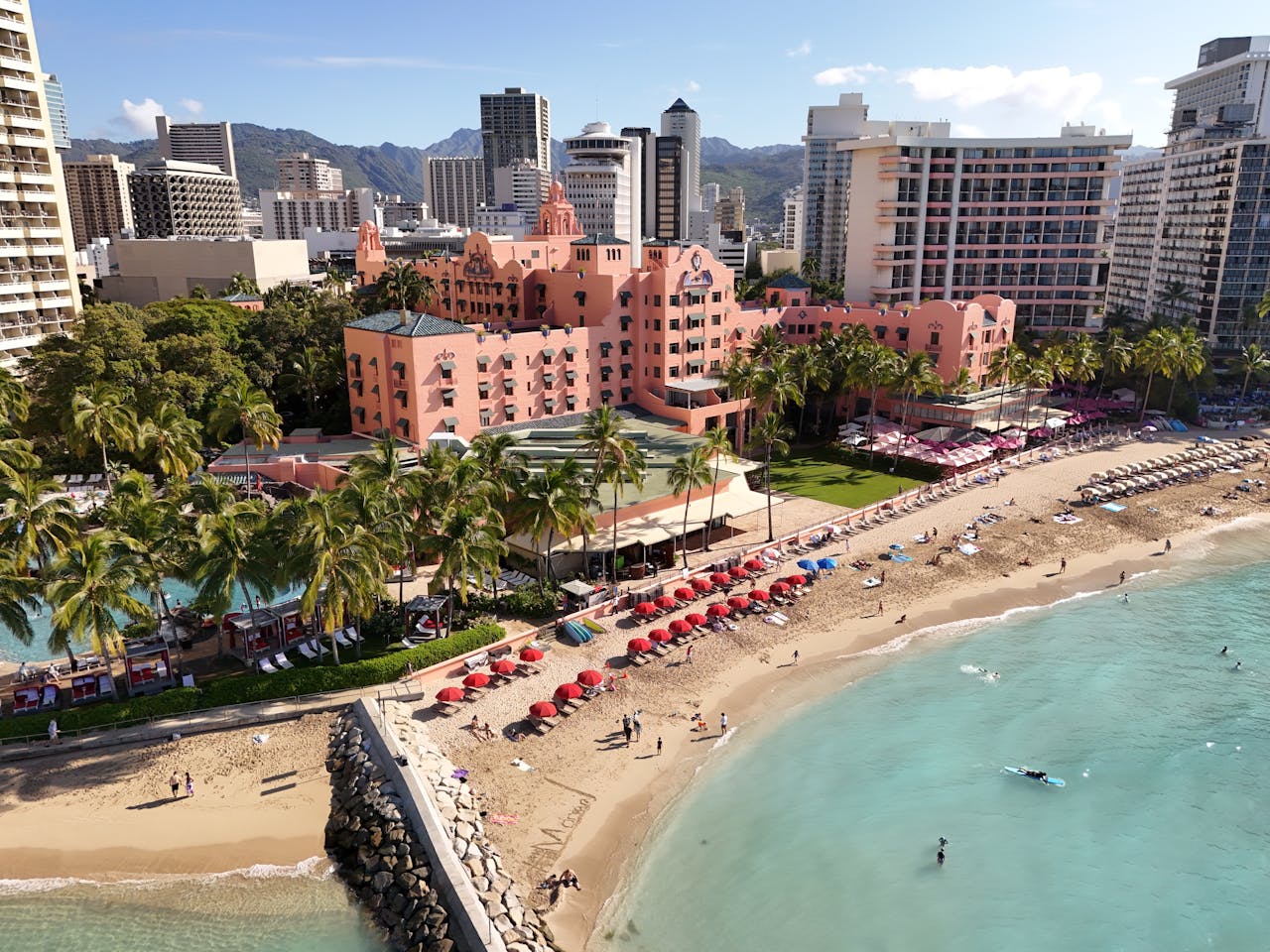 Stunning aerial shot of Waikiki Beach and iconic pink hotel in Honolulu, Hawaii.